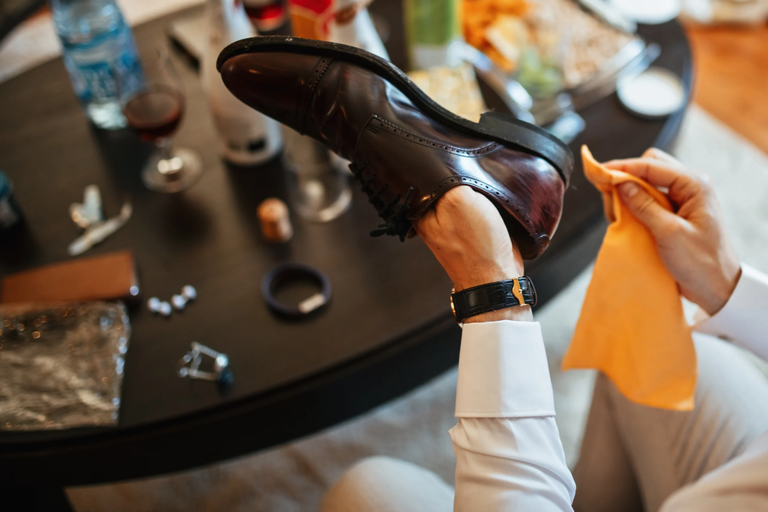 close-up-man-cleaning-shoes-while-getting-ready-wedding-ceremony